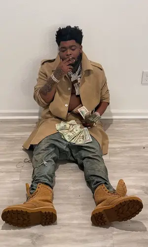 BossMan Dlow wearing Louis Vuitton jacket
