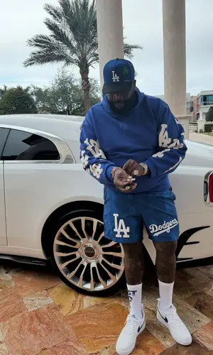 Rick Ross’ Outfit in Pro Standard Shorts, New Era Cap & Nike Socks (2025)