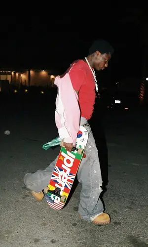 Asake wearing Golden Goose belt