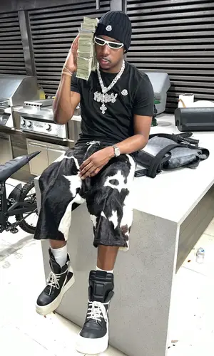 Rob49 wearing Louis Vuitton backpack