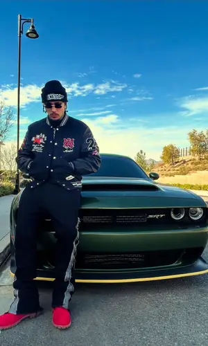 LiAngelo Ball’s Outfit in Amiri Jacket, Cartier Eyewear & Mitchell & Ness Hat (2025)