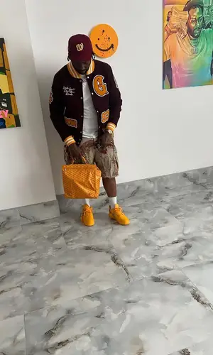 Peezy wearing Goyard backpack