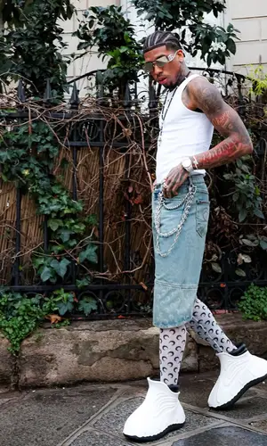 NLE Choppa’s Outfit in Marine Serre Top, NLE Choppa Merch  Boots & Dolce & Gabbana Eyewear (2025)