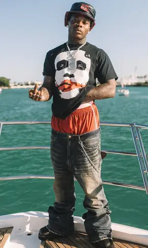 Asake wearing Balenciaga boots