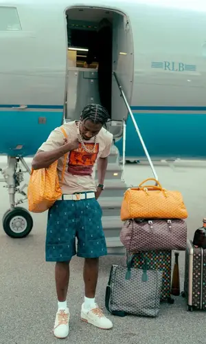 Lil Tjay’s Outfit in Louis Vuitton T-Shirt, Goyard Bag & Tyler The Creator Merch (2025)