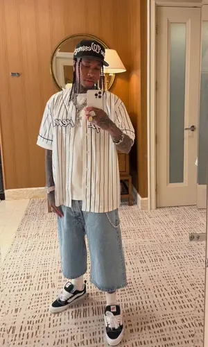 Tyga’s Outfit in Supreme Shirt, Marithe + Francois Girbaud Shorts & Hanes Socks (2025)