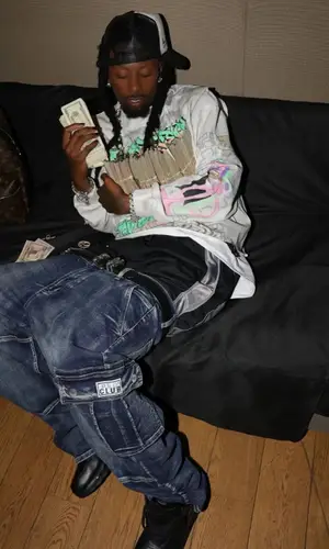 Playboi Carti wearing Louis Vuitton backpack
