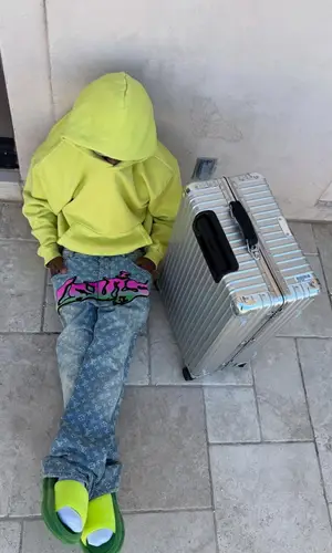 Kai Cenat wearing Rimowa bag