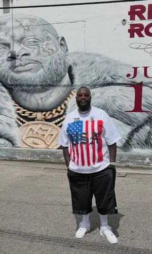 Rick Ross’ Outfit in Heights District T-Shirt, Pro Club Shorts & Nike Sneakers (2026)