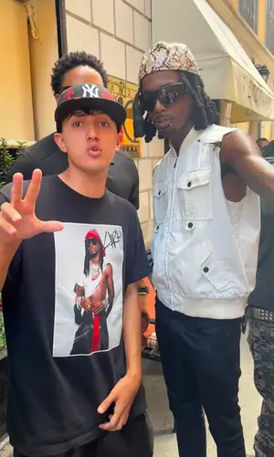 Playboi Carti’s Outfit in Dolce & Gabbana Jacket, Saint Laurent Jeans & Playboi Carti Merch Cap (2026)