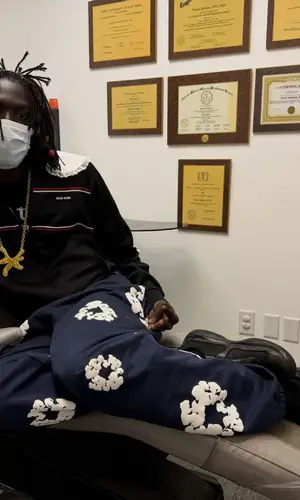 Pz' wearing Denim Tears pants