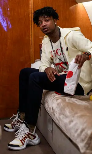 21 Savage wearing Gucci sock