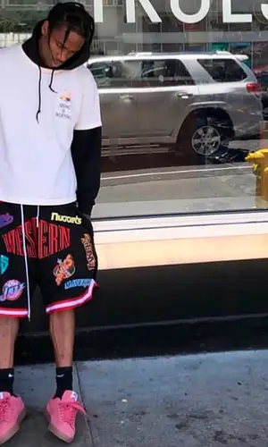Travis Scott wearing Supreme suit