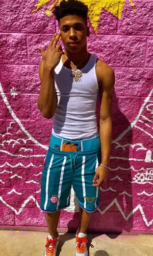 NLE Choppa wearing KidSuper shorts