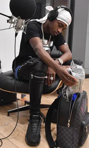 Lil Tjay wearing Louis Vuitton backpack