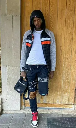 Famous Dex wearing Herschel Supply Co bag
