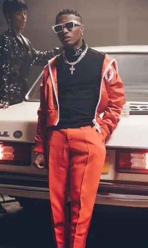 Wizkid wearing Versace jacket