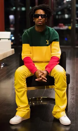 21 Savage wearing Louis Vuitton sweatshirt