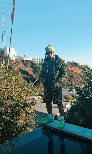 J Balvin wearing 99%IS hat