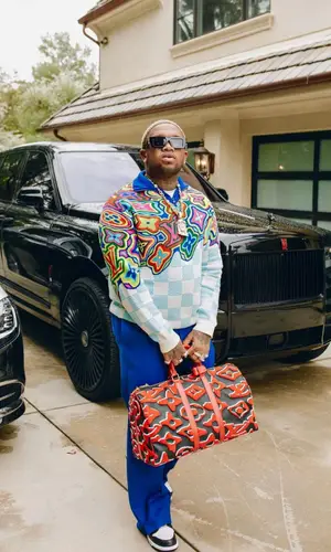 Mustard wearing Louis Vuitton sweater