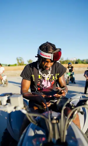 Polo G wearing Louis Vuitton bag