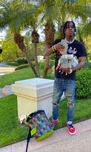 Polo G wearing Gucci backpack