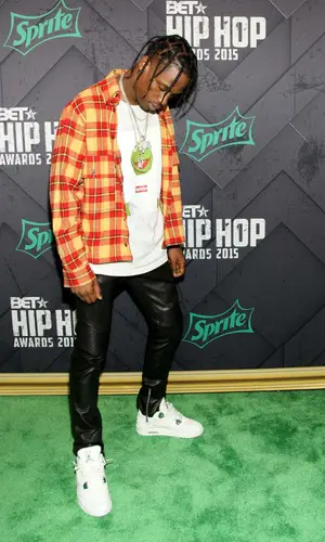 Travis Scott wearing Gosha Rubchinskiy shirt