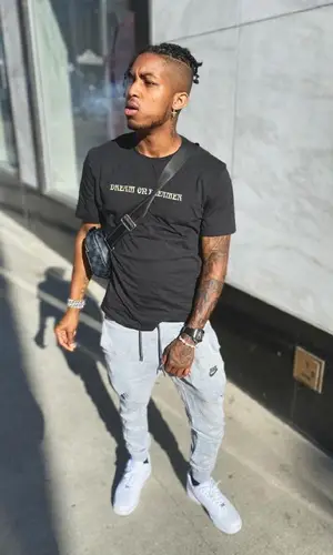 DDG wearing Louis Vuitton bag
