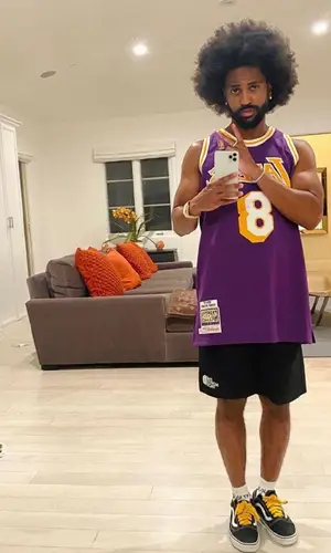 Big Sean wearing Mitchell & Ness jersey