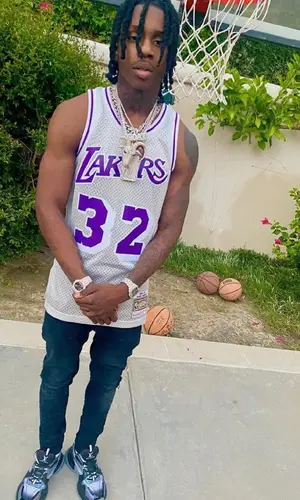 Polo G wearing Mitchell & Ness jersey