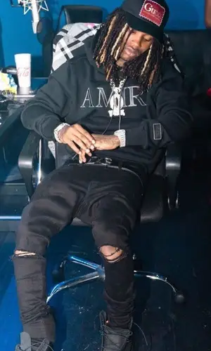 King Von wearing Amiri jeans