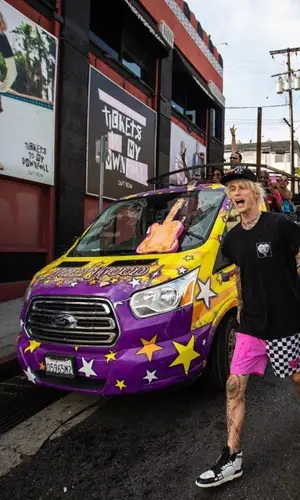 Machine Gun Kelly wearing Machine Gun Kelly Merch shorts