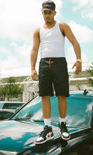 Myke Towers wearing Supreme sock