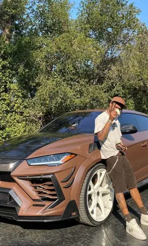 Travis Scott wearing Supreme suit
