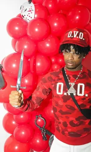 21 Savage wearing Bape cap