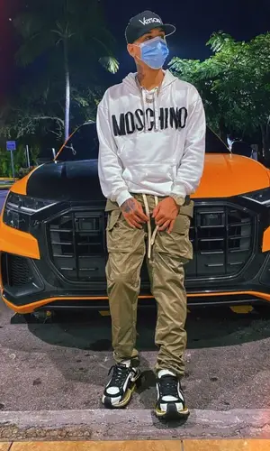 Noriel wearing Versace cap
