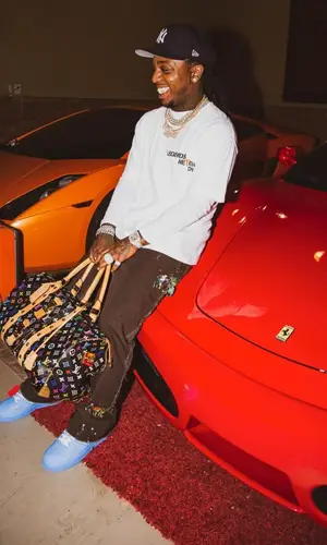 Jacquees wearing Louis Vuitton bag