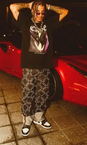 Rauw Alejandro wearing Stolen Girlfriends Club t-shirt