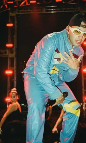 Feid wearing KidSuper jacket