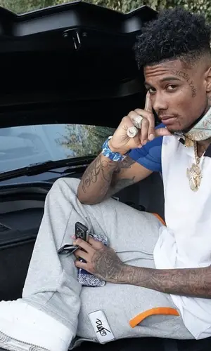 Blueface wearing FashionNova shirt