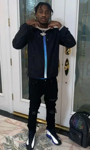 Lil Tjay wearing Louis Vuitton backpack