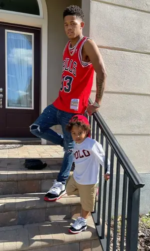 YK Osiris wearing Louis Vuitton bag