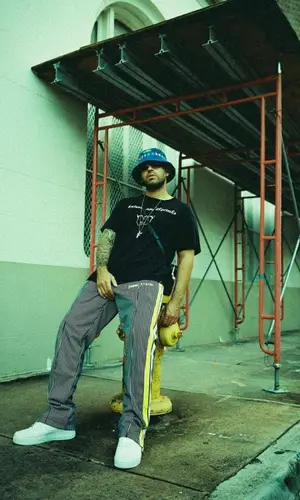 Feid wearing Enfants Riches Deprimes t-shirt