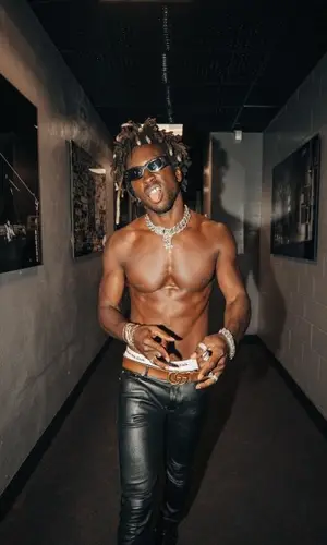 Saint JHN wearing Saint Laurent pants
