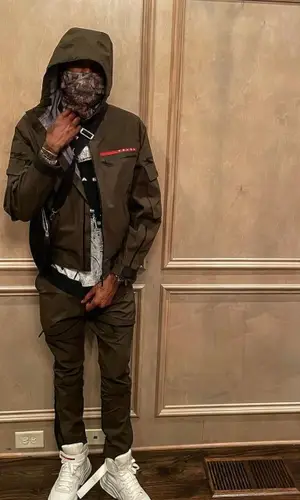 Meek Mill wearing Prada trousers