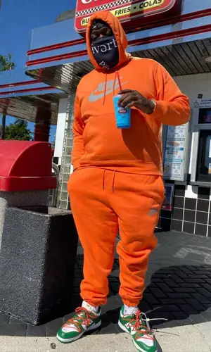 Rick Ross wearing Nike hoody