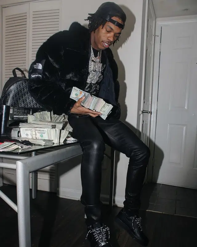 Lil Baby outfit in The North Face, Louis Vuitton, and Supreme, 2021