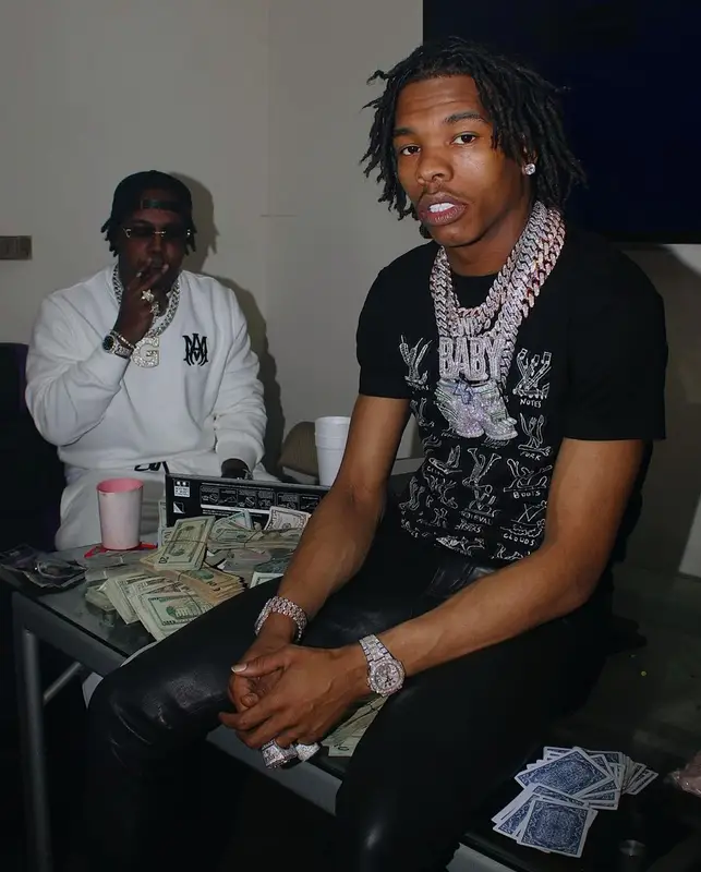 Lil Baby outfit in The North Face, Louis Vuitton, and Supreme, 2021