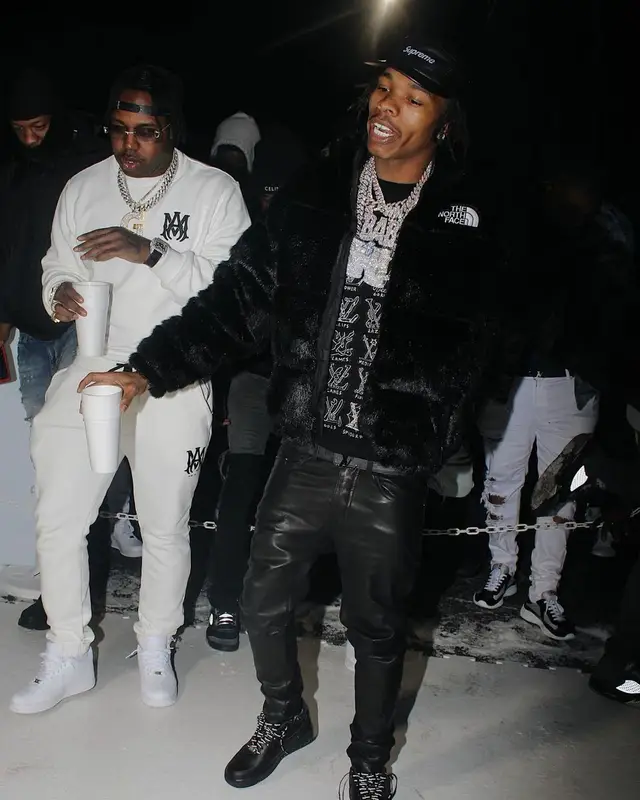 Lil Baby outfit in The North Face, Louis Vuitton, and Supreme, 2021