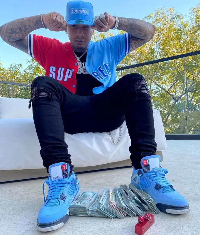 Moneybagg Yo outfit in Louis Vuitton, Supreme, and New Era, 2021